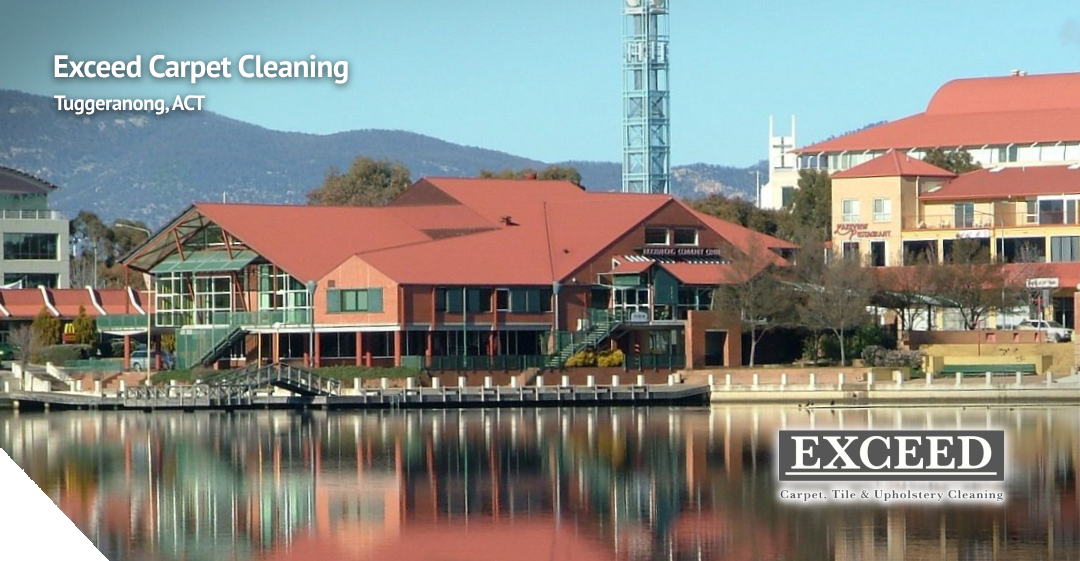 Exceed Carpet Cleaning logo and banner showcasing Tuggeranong, ACT, with a waterfront view of local buildings and mountains in the background, emphasizing professional cleaning services.