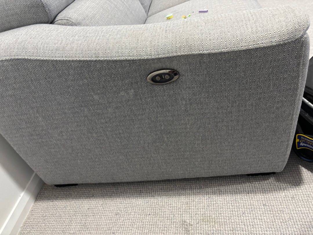 Upholstered lounge chair with visible wear and minor stains, showcasing the aftermath of a cleaning service by Exceed Carpet Cleaning in Googong, NSW.